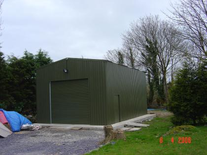 Exterior of machinery shed with full steel roller door and PA side door