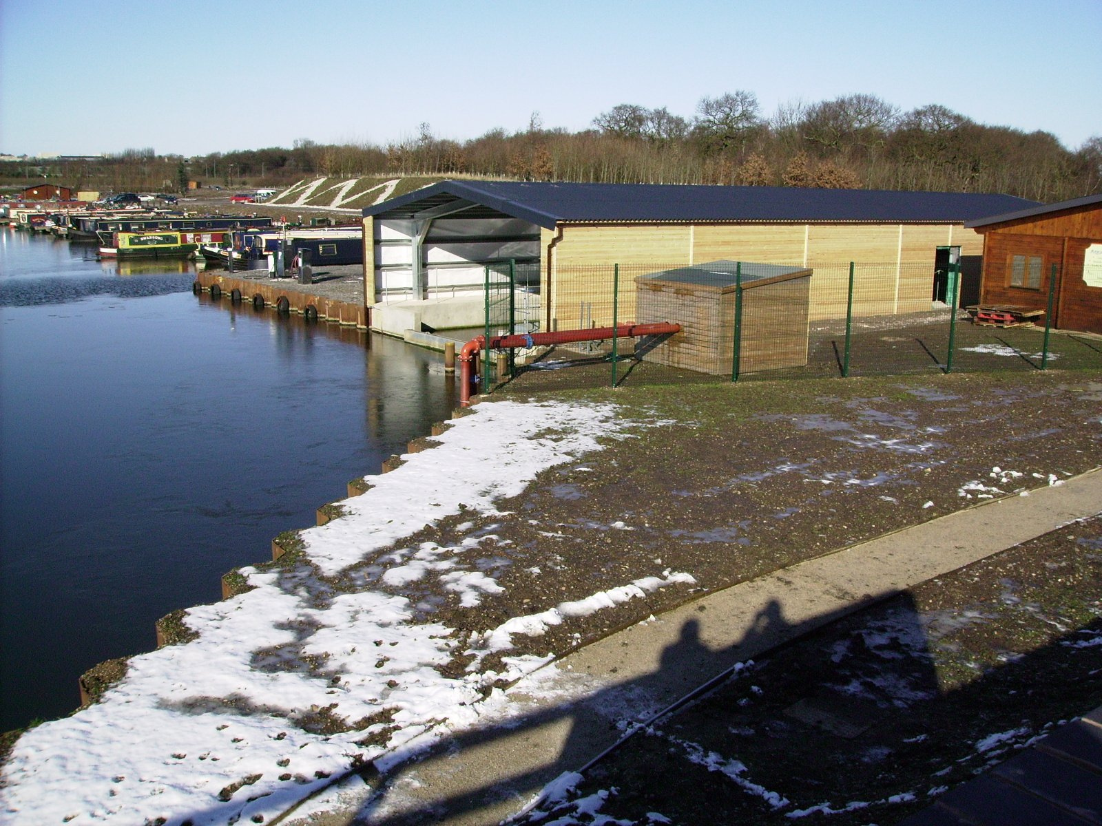 Steel framed boathouse with woodern exterior