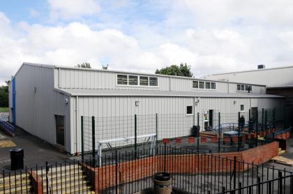 Exterior of sports complex and office building in white steel finish